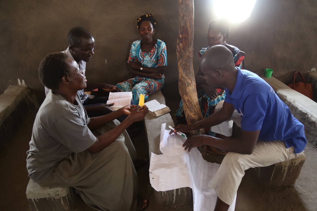 A small group reading the Bible and planning together